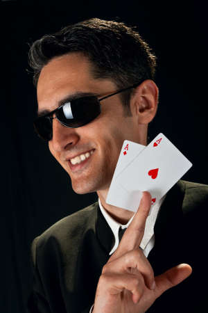 Young lucky gambler with cards in hand 