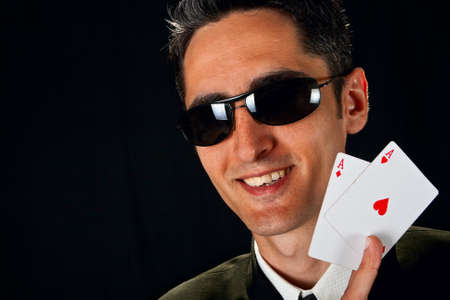 Young lucky gambler with cards in hand の写真素材