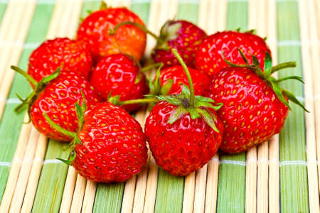 Juicy ripe strawberries on the green grass napkinの写真素材