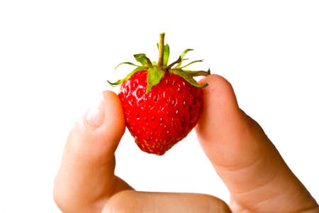 Juicy ripe strawberries in child hand  Isolated on white background の写真素材