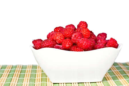 ripe juicy cherries on a white napkin on the grassy saucer