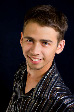 Portrait of successful young man on dark backgroundの写真素材