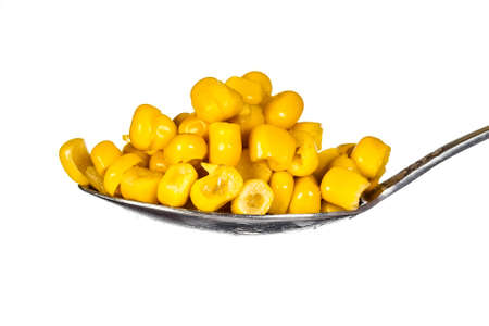 canned corn in spoon isolated on whiter backgroundの写真素材