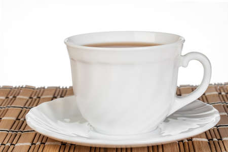 White cup of tea on wooden tableの写真素材