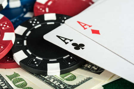 Group of chips, money and poker cards on the green cloth 