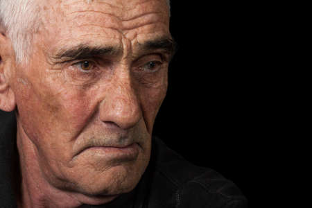 portrait of an elderly man on black backgroundの写真素材