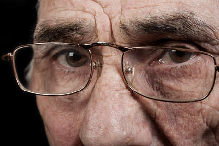 portrait of an elderly man on black backgroundの写真素材