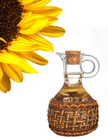 sunflower and jug with sunflower oil isolated on white backgroundの写真素材