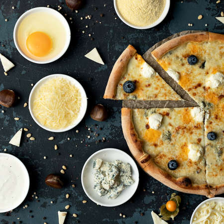 Delicious Pizza making process. Ingredients and whole cooked pizza on black background. High angle...