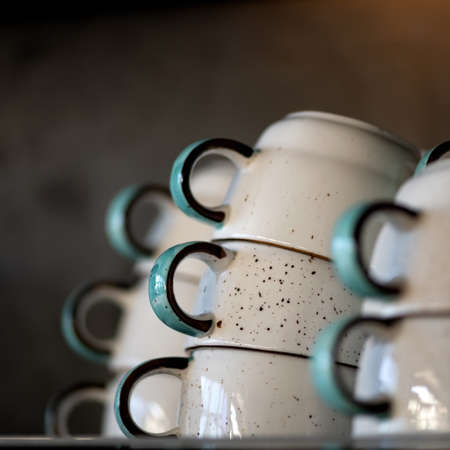 Coffee cups pyramid. Clean clay cups dry on table. Close up shot, side view. Soft focus. Copy space.の写真素材