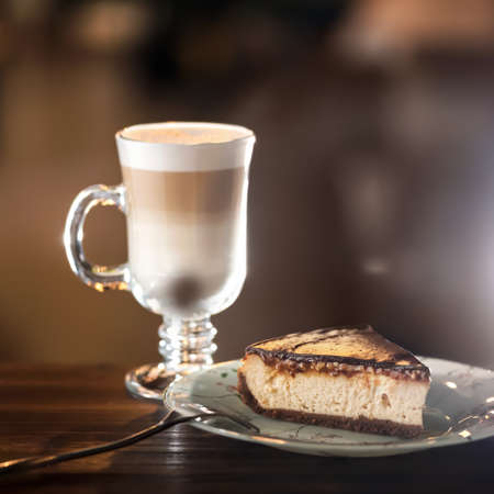 Piece of cheese cake and Latte coffee. Morning Concept. Romantic sweet gift for lovely person. Holiday or festive food concept. Soft focus. Copy space.の写真素材