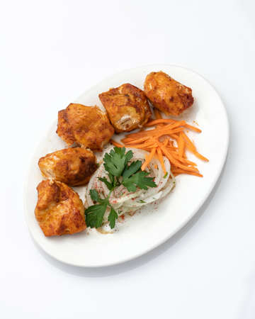 Fried juicy meat fillet or filet with vegetable salad. Food plate isolated on white background. Top view. Vertical format. Copy space.の写真素材