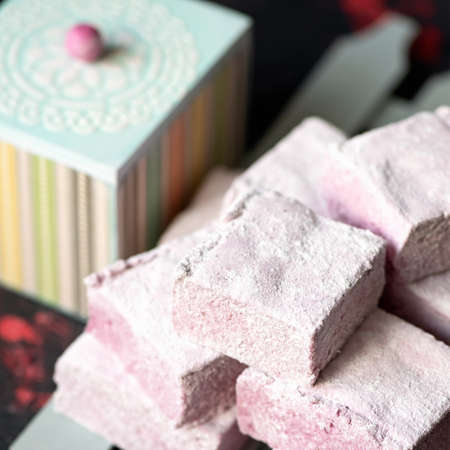 Berry marshmallow airy dessert, fluffy sweetness. Stack of pink pastille pieces. Puffy natural paste...