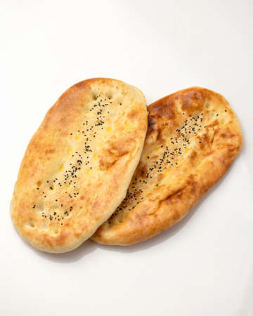 Two wheat bread buns with sesame seeds. Whole loafs shadow isolated on white background.の写真素材