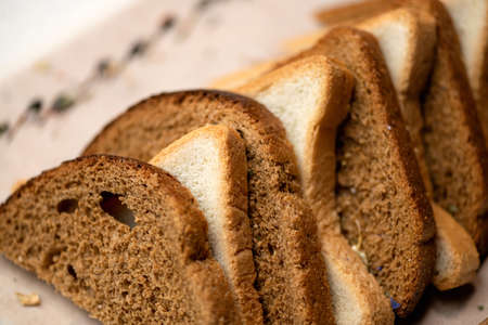 Bread mixture. Assorted slices or set of wheat and rye bread. Horizontal format. Close-up shot. Soft focus.の写真素材