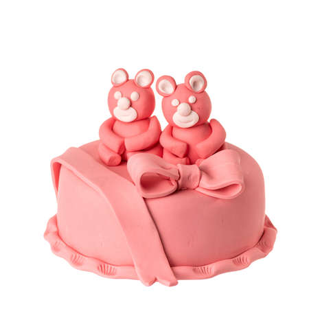Pink Cake with figurines of Bears couple in love. Sweet gift isolated on white background. Wedding anniversary, honeymoon, Valentine Day present. Dessert with marzipan.の写真素材