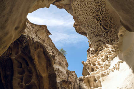 Heavenly window. Sky in opening between rocks.の写真素材