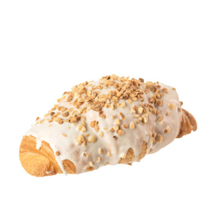 Croissant with nuts and white glaze isolated on white background. Traditional French pastries.の写真素材