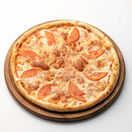 Whole pizza with cheese, tomatoes and minced meat on wooden round cutting board isolated on white background. Classic italian food. Nutrition dinner or lunch. Square format.の写真素材