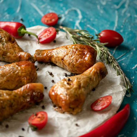 Baked stuffed chicken legs on parchment paper. Close-up shot. Soft focus. Copy space.の写真素材