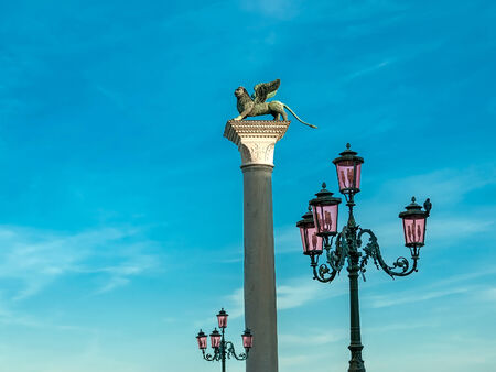 Photo of St.Mark?s lion statue with streetlamps,Venice,Italyの写真素材