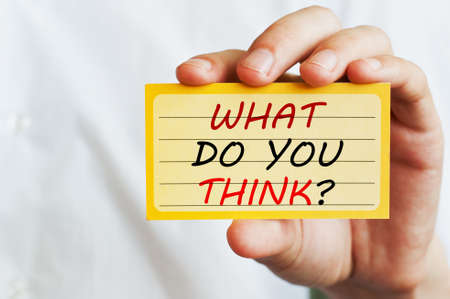 Man Holding a Card With a Question What Do You Think?の写真素材
