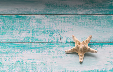 Starfish on blue scratched old wooden backgroundの写真素材