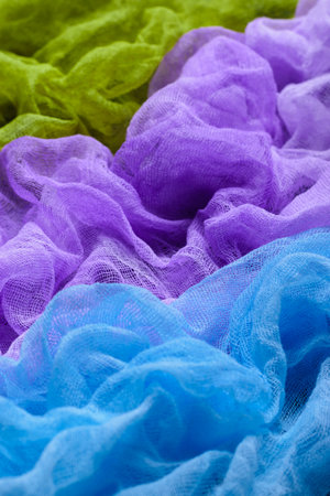 Handmade dyed textured gauze fabric background. Blue, purple and green colors. の写真素材