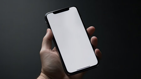 Apple iPhone X in hand with white screen on black backgroundの素材