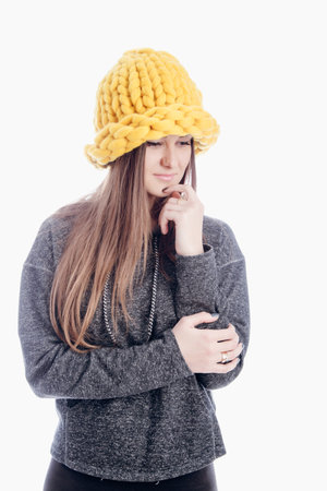 Pretty young woman wearing yellow hat isolated on white background