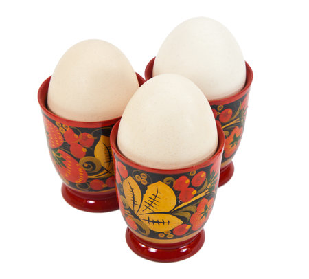 An organic free-range egg in a color egg cupsの写真素材