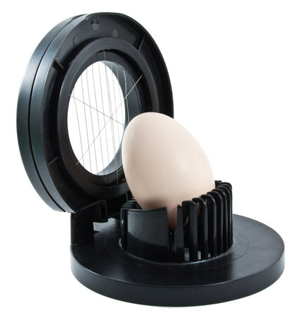 Egg slicer with one egg on a white backgroundの写真素材