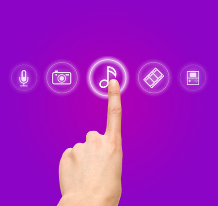 Hand choosing melody-sound film symbol from media iconsの写真素材