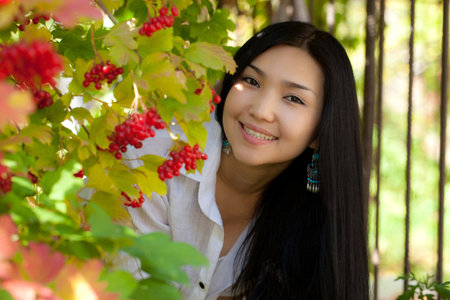 Portrait of a girl in the garden. Viburnum. Rowanの写真素材