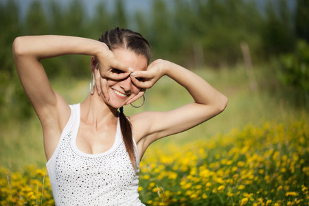 Portrait of a girl in the flower meadow. The girl represents the glassesの写真素材