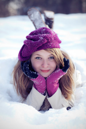 Smiling Woman Lying in the Snowの写真素材