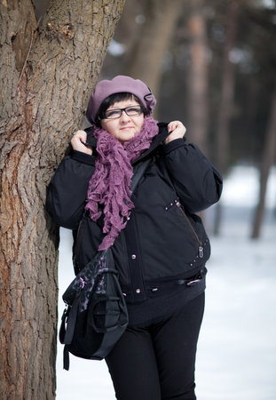 The woman leaned against a treeの写真素材