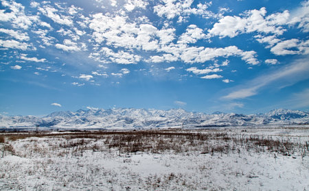Panoramic landscape of snowy mountains in the springの写真素材