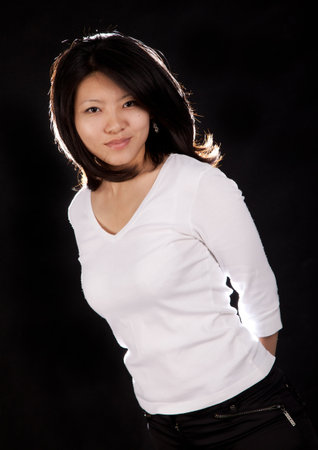 A korean girl on a black background with backlightの写真素材