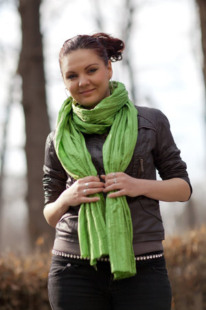 A girl in a green scarf in the parkの写真素材