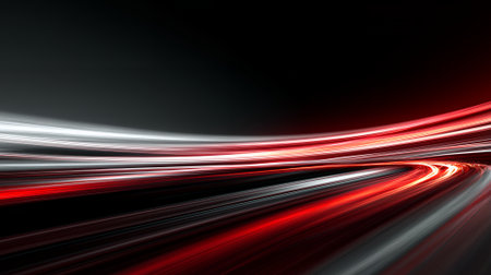 Dynamic red and white light trail motion blur abstract on dark background.の素材
