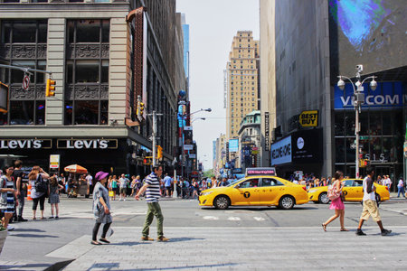 People are walking in Manhattan with yellow cab on sunday morning