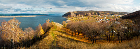 Panorama landscape of the floodplain. Mountain landscape with a settlement on the banks of the river.の写真素材