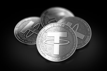 Stack of four silver Tether (USDT) coins laying on the black background. 3D renderingの写真素材