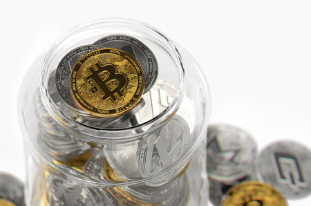 Glass jar full of different cryptocurrencies with golden Bitcoin on the top. Cryptocurrency investment concept. Realistic 3D renderingの写真素材