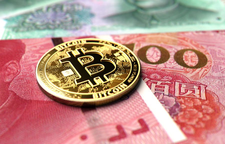 Close-up shot on Bitcoin coin laying on Chinese Yuan bills. Price of Bitcoin in China concept. 3D renderingの写真素材