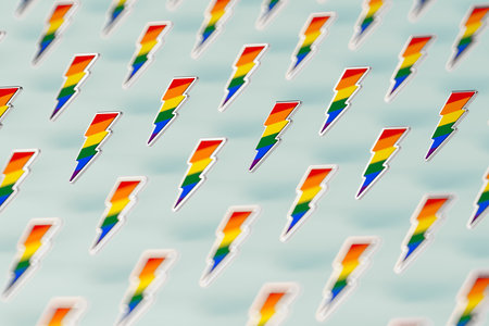 Blurry closeup shot on LGBT lightning bolt rainbow pride symbol isolated on green background. Gay,...