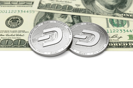 Two Dash coins (with 2019 updated logo) laying on dollar bills with copy space below. Desirable cryptocurrencies concept. 3D renderingの写真素材