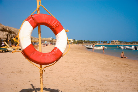 Lifebuoy On Sandy Beach on a stickの写真素材