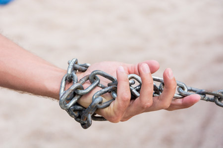 Hand with CHAIN metal and sand